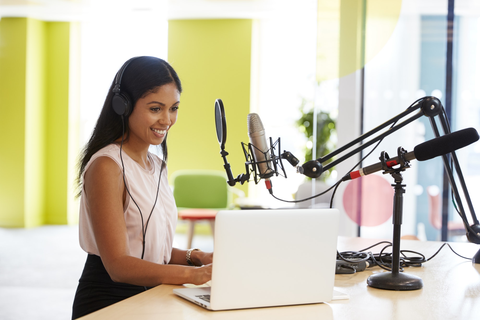 young-mixed-race-woman-recording-a-podcast-in-a-studio